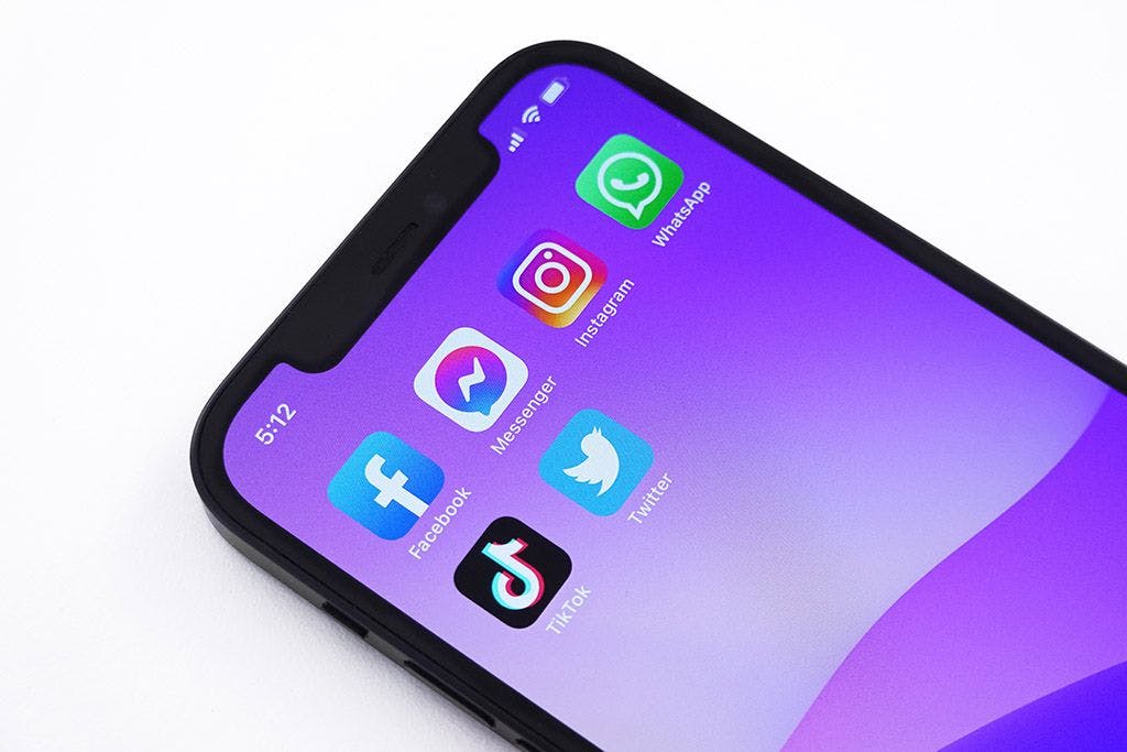 A phone with facebook instagram whatsapp and tiktok on it.